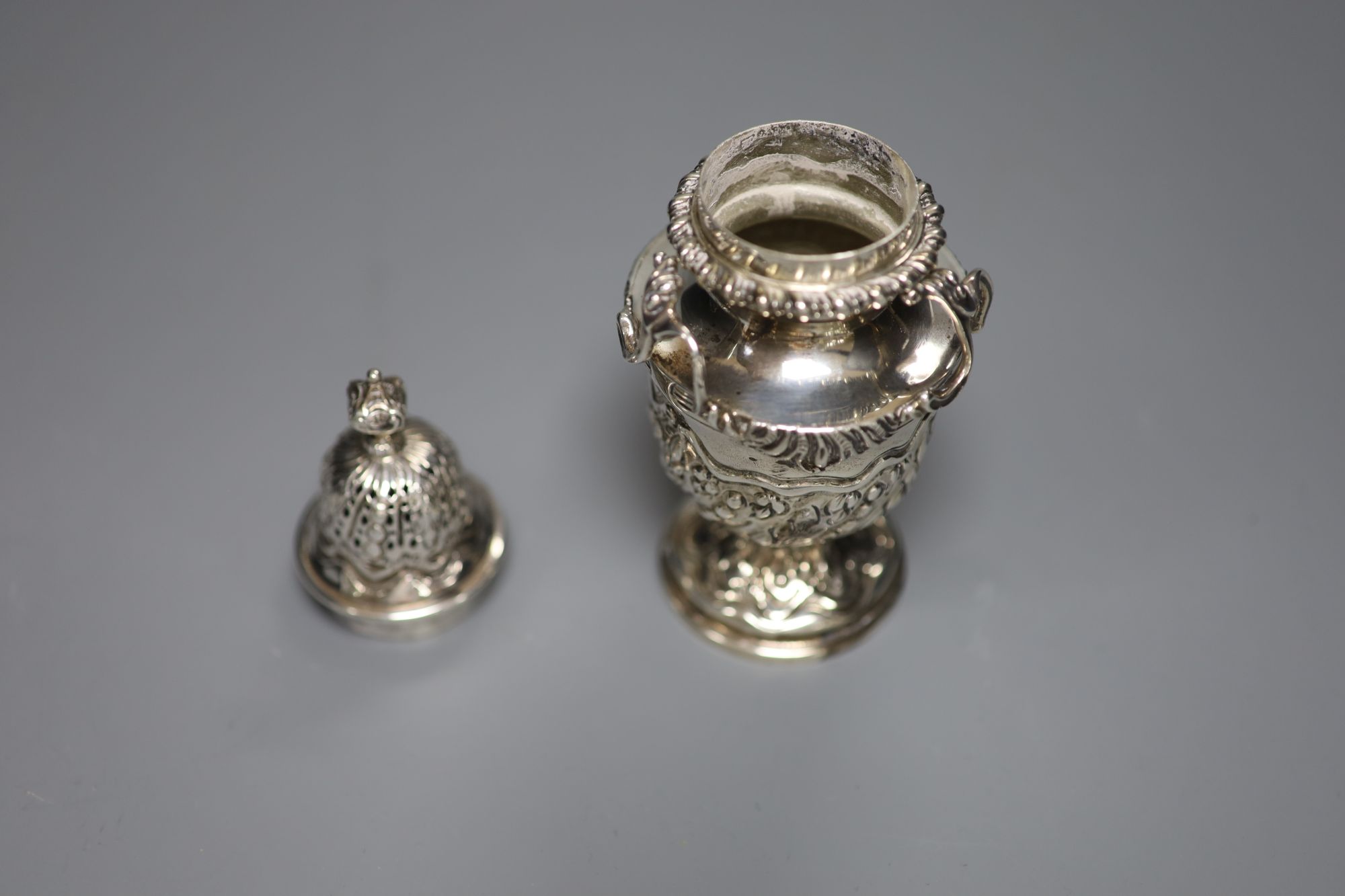 An ornate late Victorian silver sugar castor by William Comyns, London, 1897, 16.2cm, 7oz.